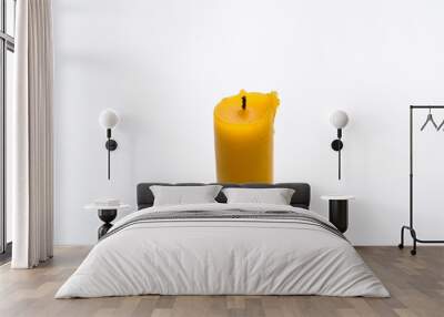 Yellow candle isolated on a white background Wall mural