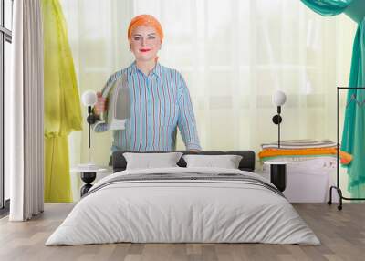 A Jewish housewife in a headdress is engaged in ironing clothes. Wall mural