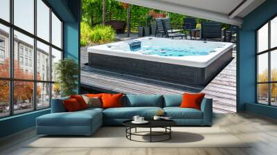 large hot tub embedded in the backyard terrace. a sunny summer's day in the shelter of a green garde Wall mural