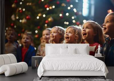 A choir of children singing carols on a festively decorated stage with onlookers gathered around. Wall mural