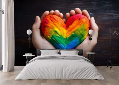 Close-up of painted hands forming a heart showcasing rainbow colors.  Wall mural