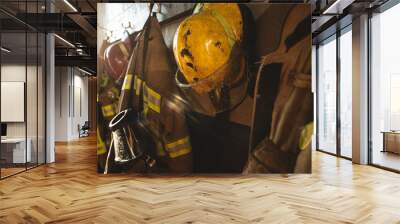 Firefighter protection gear hanging on fire station wall Wall mural