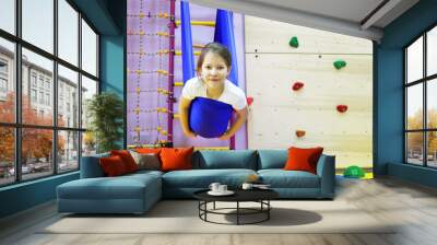 child girl in a hammock at the children's center for children with special needs and correction is undergoing a course of rehabilitation treatment autism flight coup Wall mural