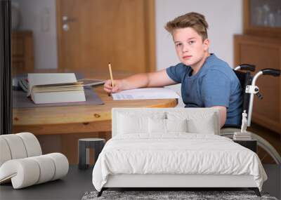 boy in wheelchair doing homework Wall mural