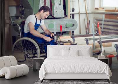 worker in wheelchair in a carpenter's workshop Wall mural