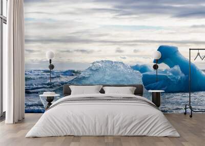 A large piece of ice is floating in the ocean Wall mural