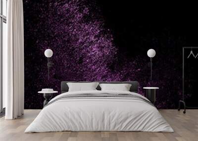 Purple sequins glisten with dust isolated on a black background. Vertical abstract background with sparkling dust Wall mural