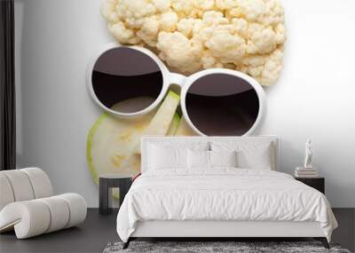 Tasty art / Quirky food concept of cubist style female face in sunglasses made of fruits and vegetables, isolated on white. Wall mural