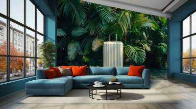 A luggage suitcase stands against green exotic tropical plants wall. Travel and tropical vacation concept. Wall mural