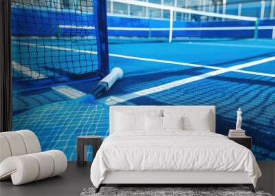 Blue paddle tennis net and court field background. Generative AI Wall mural