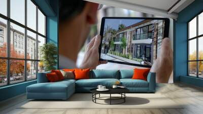 Real estate agent showing a virtual tour of a property on a tablet Wall mural