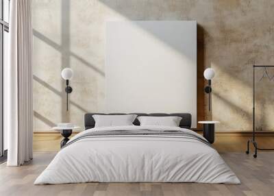 A blank light colored canvas, on a warm beige wall backdrop Wall mural