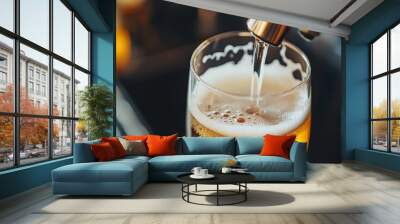 A close up of a glass of craft beer being poured from a tap, capturing the motion of the liquid and the bubbles forming as it fills the glass Wall mural