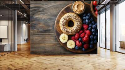 A cozy breakfast scene with a peanut butter and honey bagel, toasted to perfection and served with a side of fresh fruit, set on a rustic wooden table Wall mural