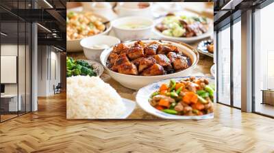 A festive Chinese dinner table set with a variety of dishes, including braised pork belly, stir-fried vegetables, and steamed rice Wall mural