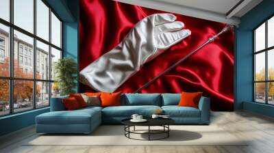 A magician's white gloves next to a sparkling wand, isolated on a deep red silk background for an elegant, luxurious magic accessory look Wall mural