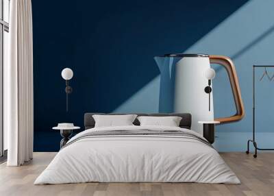 A minimalist electric kettle with a wooden handle on a cobalt blue background, creating a striking contrast with clean shadows Wall mural