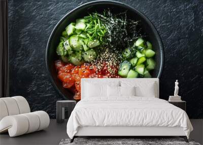 A minimalist poke bowl with simple ingredients like avocado, cucumber and seaweed, on a black slate plate, with stark lighting to highlight textures Wall mural