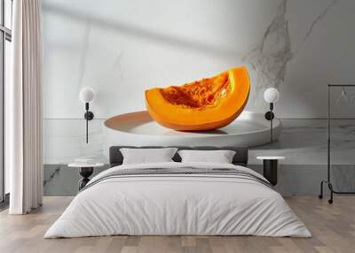 A minimalist scene of a large pumpkin sliced in half, revealing a rich orange interior, placed on a simple white plate on a polished marble counter Wall mural