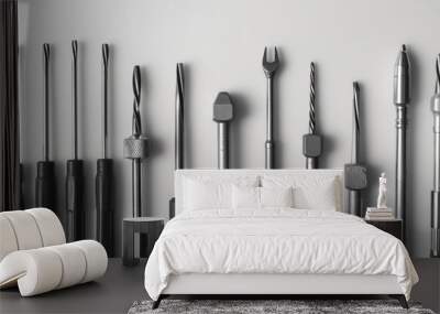 A neatly arranged set of screwdrivers with various heads, each placed precisely on a smooth, monochrome background Wall mural