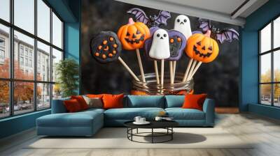 A selection of Halloween lollipops with ghost, pumpkin, and bat shapes, presented in a glass jar with a festive ribbon Wall mural