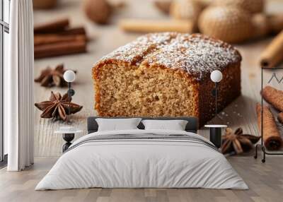 A slice of fresh pain d'epices, a spiced French gingerbread, isolated on a light wooden background Wall mural