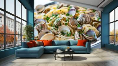 A traditional Italian seafood feast featuring a platter of linguine alle vongole (linguine with clams), garnished with fresh parsley and garlic Wall mural