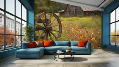 An old wagon wheel leaning against a wooden fence, surrounded by tall grasses and wildflowers, with a weathered barn in the background Wall mural