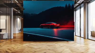 Bright red car parked on a dark charcoal road at night Wall mural