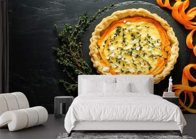 Carrot and feta tart with puff pastry, isolated on a black background with fresh thyme and carrot ribbons Wall mural