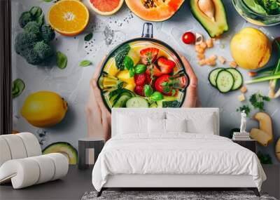 Close up shot of a person's hands blending fruits and vegetables, with fresh ingredients laid out on the counter Wall mural