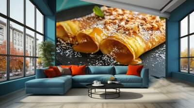 Crepes with dulce de leche and toasted coconut, served on a matte black slate plate with a bright teal background Wall mural