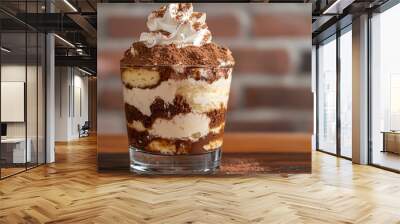 Tiramisu topped with a dollop of whipped cream, against a rustic brick wall background Wall mural