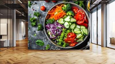 top view of a bowl with fresh salad made of raw vegetables and sauces on the table Wall mural