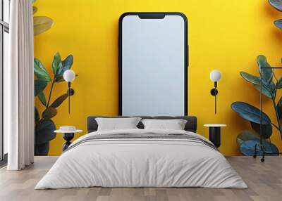  A modern smartphone with a sleek black frame and a blank white screen is displayed against a vibrant yellow background. The phone is centered and viewed from above, emphasizing its minimalist design  Wall mural