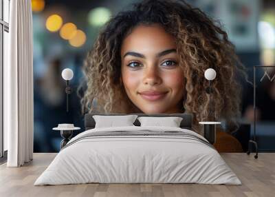  Inclusive image of happy blasian woman working on computer in creative agency office workplace. Young successful mixed race female businesswoman talking on client video call team meeting Wall mural