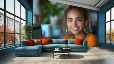  Inclusive image of happy blasian woman working on computer in creative agency office workplace. Young successful mixed race female businesswoman talking on client video call team meeting Wall mural