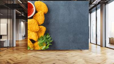 Delicious chicken nuggets on black background. Cooked or raw chicken nuggets Wall mural