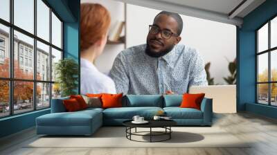 African hr manager listening to caucasian applicant at job interview Wall mural