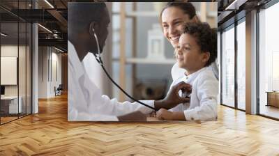 African male pediatrician hold stethoscope exam child boy patient Wall mural