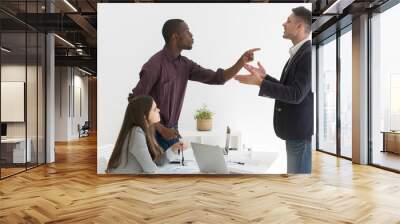 Angry multiethnic colleagues disputing during business meeting, African American worker blaming Caucasian partner for mistake, coworkers disagree on project, argue at company briefing in office Wall mural