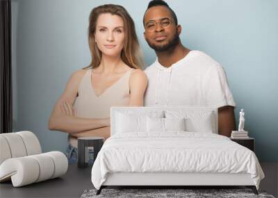 Attractive multiracial couple posing for photo in studio. Wall mural