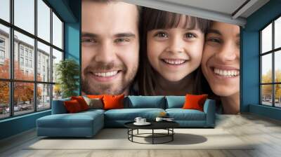 Beautiful little daughter cuddles loving mother caring father cheerful parents close up, people making picture together. Happy family portrait concept horizontal photo banner for website header design Wall mural