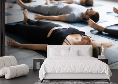 Beautiful woman meditating in Savasana pose close up, practicing yoga Wall mural