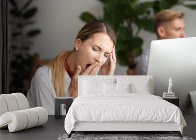 Bored businesswoman yawning at workplace feeling no motivation or lack of sleep tired of boring office routine, exhausted restless employee gaping suffering from chronic fatigue or overwork concept Wall mural