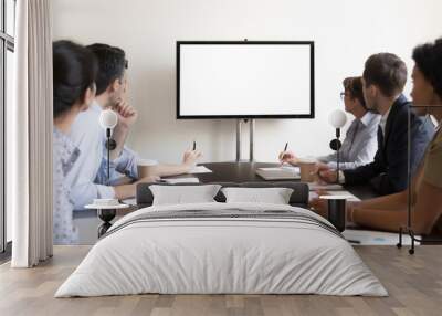 Business people group sitting at conference table looking at screen Wall mural