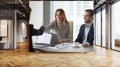 Businessman handshaking female business partner meeting in office ready for negotiations, diverse millennial colleagues shaking hand thanking for successful conference or talk. Partnership concept Wall mural