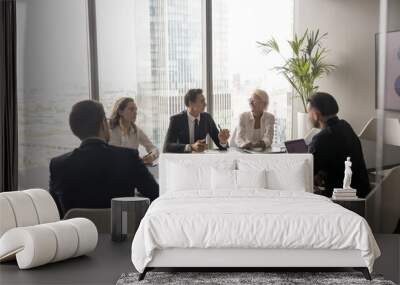 Businesspeople negotiating in conference room in modern city skyscraper office, five businesspeople gathered together, collaborating on problem solving or decision-making processes. Business workflow Wall mural