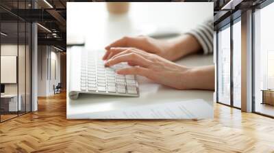 Businesswoman working on computer concept, female hands typing text on keyboard, woman using desktop for writing business emails, communicating in corporate messenger, doing job online, close up view Wall mural