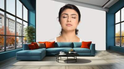 Calm Indian girl with closed eyes breathing deep, meditating Wall mural